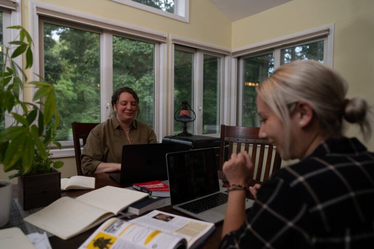 Business consultants discuss customer service training program content and measurement in an office setting