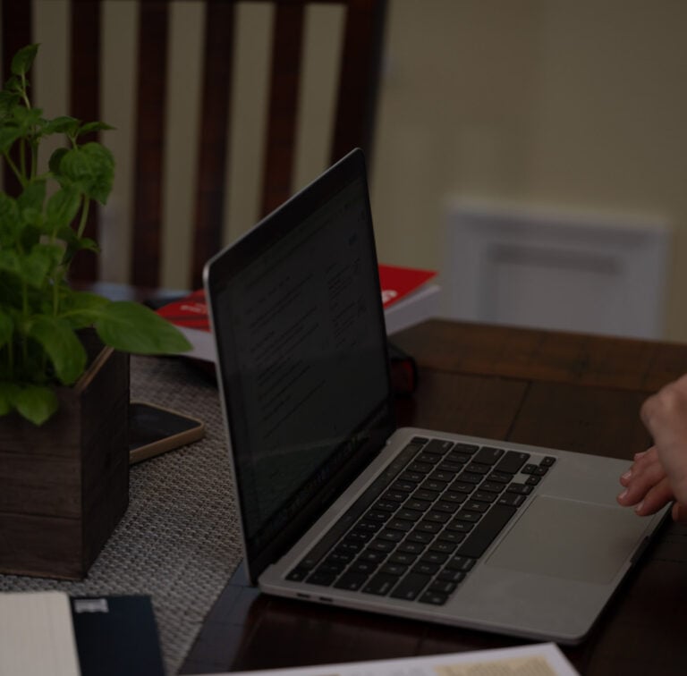 Laptop on a desk in an office showing subscription business KPIs for small business
