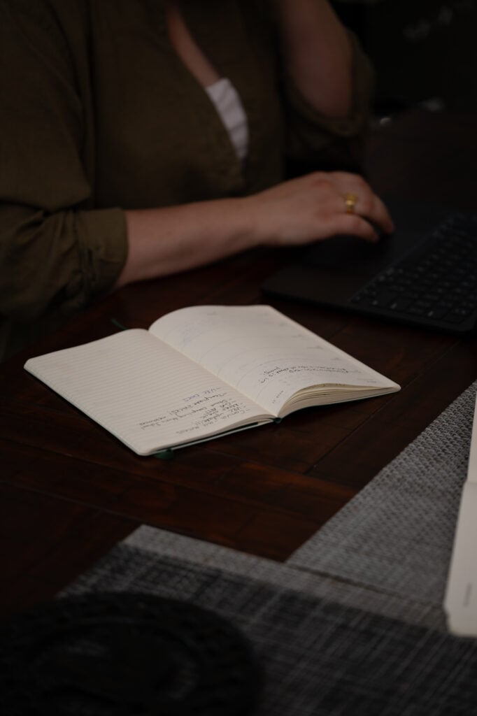Laptop and notebook being used for small business workflow planning