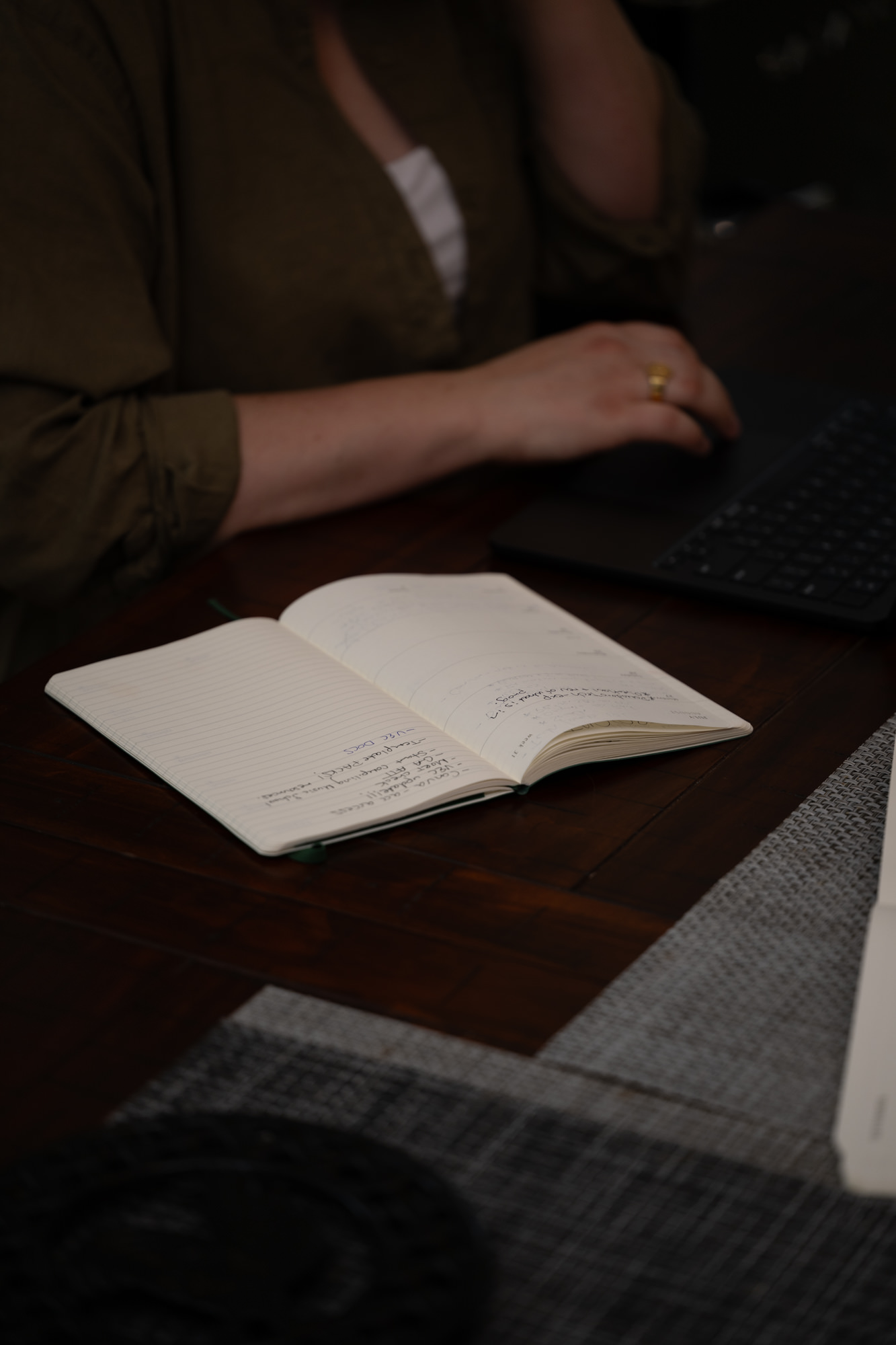 Laptop and notebook being used for small business workflow planning