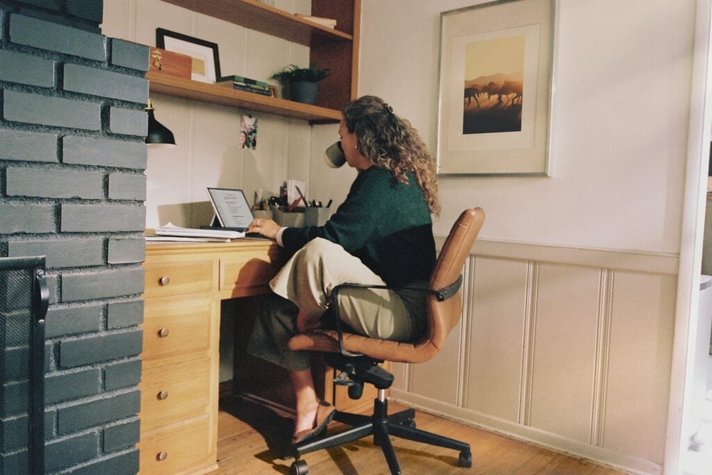 woman sitting at a desk - at work launching a subscription service business