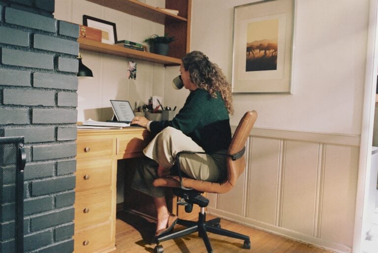 woman sitting at a desk - at work launching a subscription service business