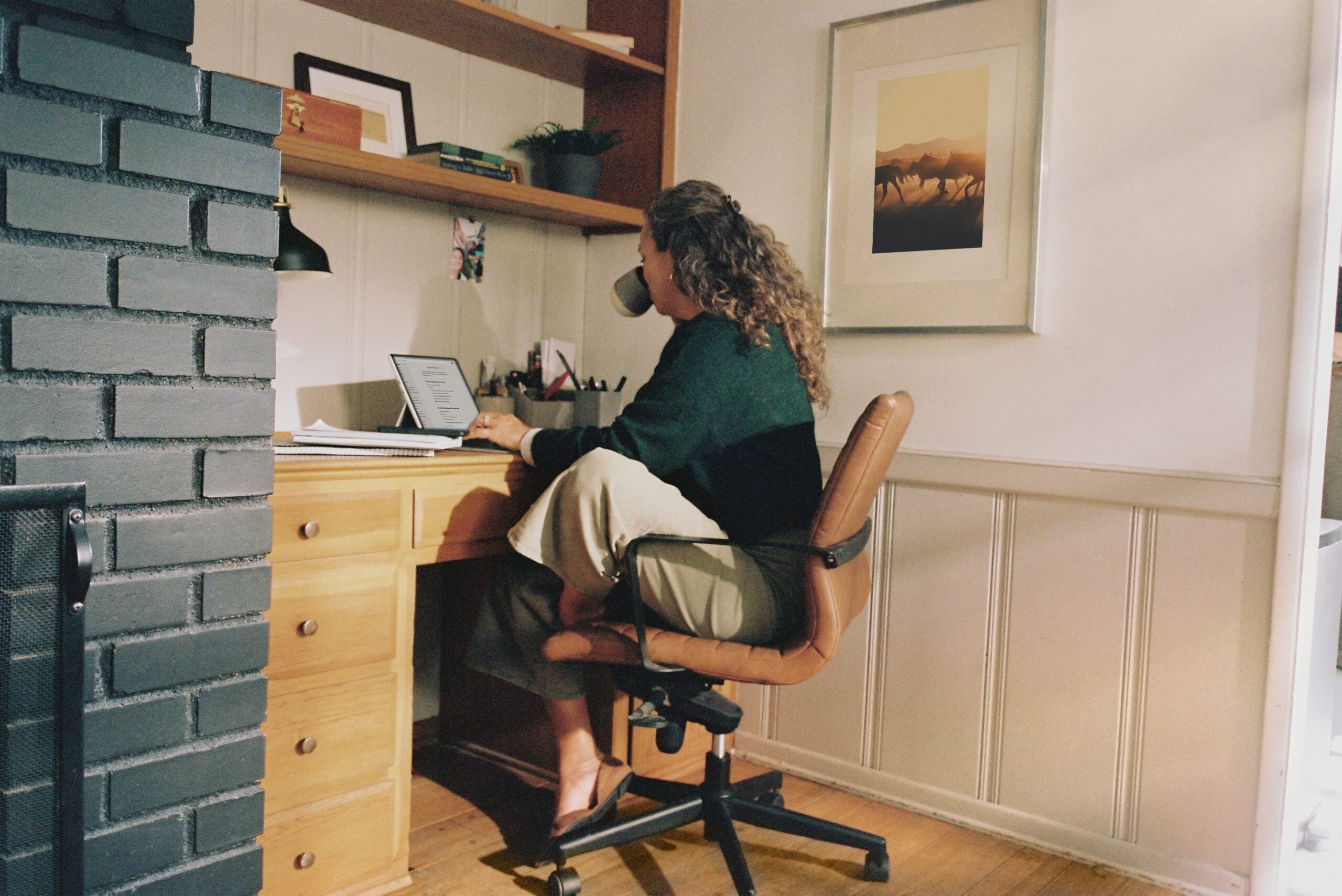 woman sitting at a desk - at work launching a subscription service business