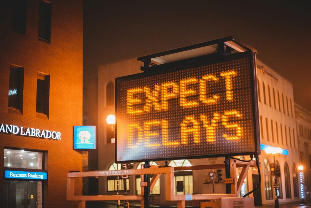 image of a traffic sign saying 'expect delays' illustrates the challenges leaders see with set backs to their deep-work workflow