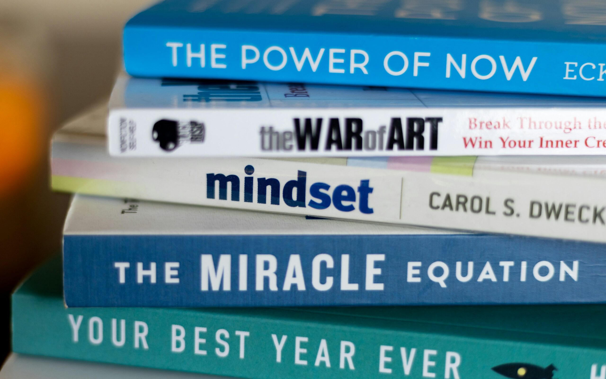 stack of mindset development books to illustrate the theme of mindset being a trap