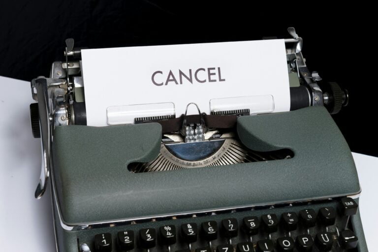 typewriter with a page showing the word 'cancel' to demonstrate subscription cancellation policies and frustration customers experience when trying to exit a service