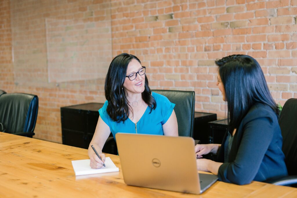 two colleagues in an office representing one-on-one workflow coaching